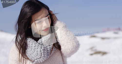 Image of Pretty young woman in sweater on ski slope