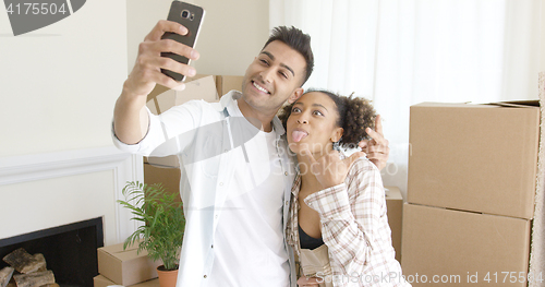 Image of Fun young couple taking their selfie