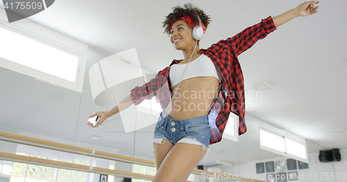 Image of Low angle view of attractive dancer in shorts