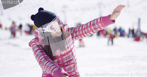 Image of Happy woman on ski holiday waving