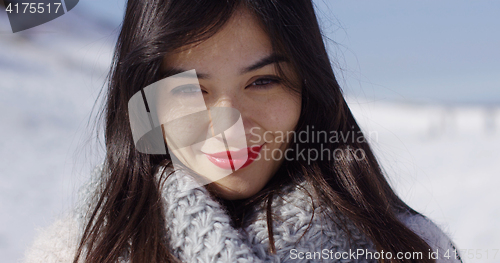 Image of Beautiful young woman in snowy landscape