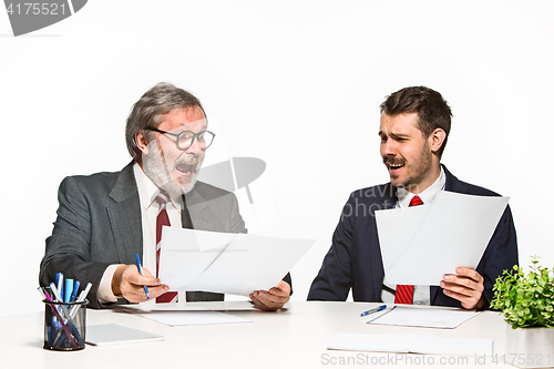 Image of The two colleagues working together at office on white background.