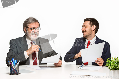 Image of The two colleagues working together at office on white background.