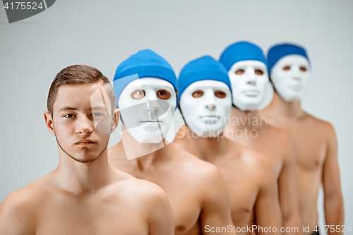 Image of The people in masks and one man without mask