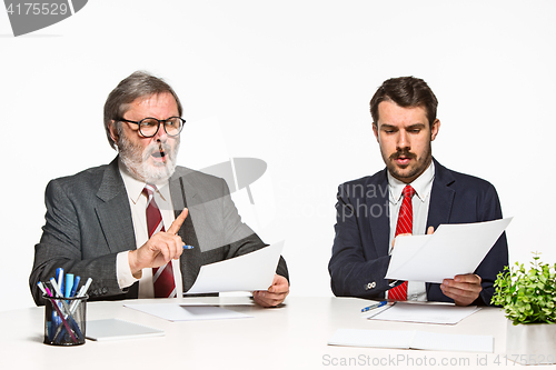 Image of The two colleagues working together at office on white background.