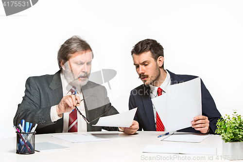 Image of The two colleagues working together at office on white background.