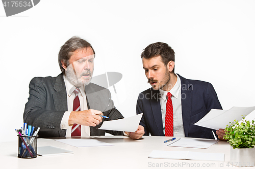 Image of The two colleagues working together at office on white background.