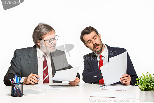 Image of The two colleagues working together at office on white background.