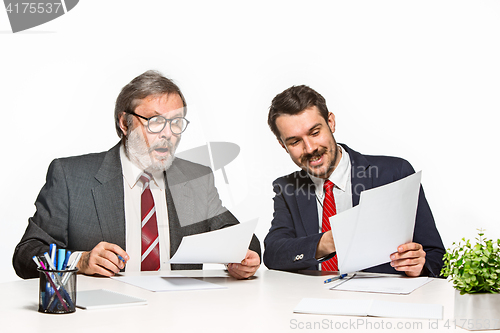 Image of The two colleagues working together at office on white background.