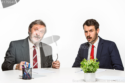 Image of The two colleagues working together at office on white background.