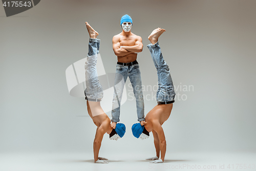 Image of The group of gymnastic acrobatic caucasian men on balance pose