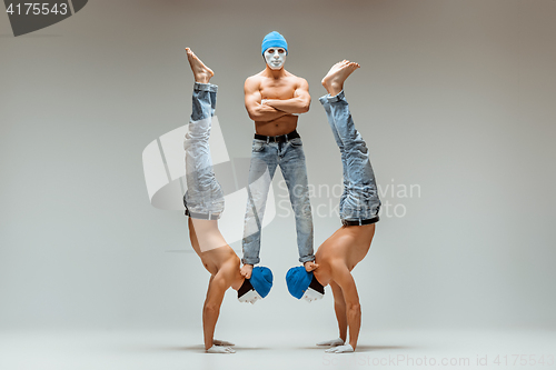 Image of The group of gymnastic acrobatic caucasian men on balance pose