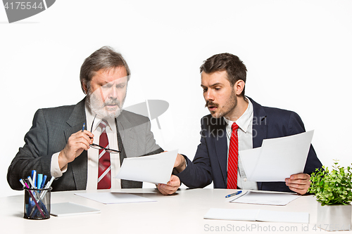 Image of The two colleagues working together at office on white background.