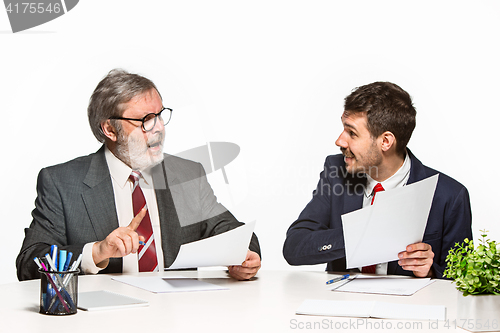 Image of The two colleagues working together at office on white background.