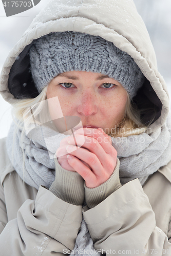 Image of Portrait of lady outdoor in snow in cold winter time.