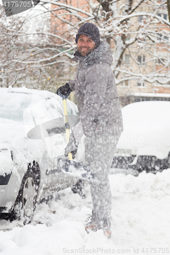 Image of Man shoveling snow in winter.