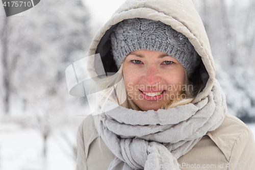 Image of Portrait of lady outdoor in snow in cold winter time.