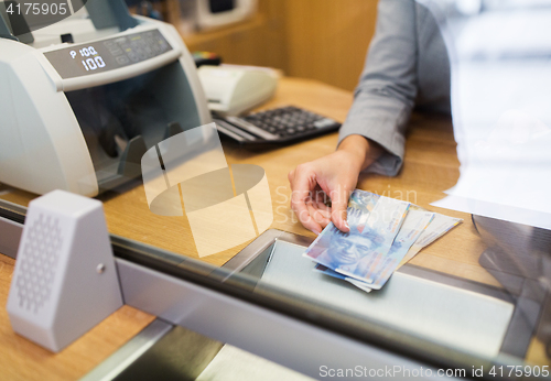 Image of clerk with swiss francs cash money at bank office