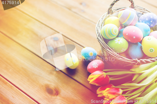 Image of close up of easter eggs in basket and flowers