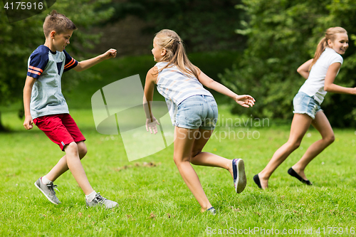 Image of group of happy kids or friends playing outdoors