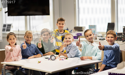 Image of happy children building robots at robotics school