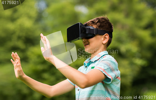 Image of boy with virtual reality headset outdoors