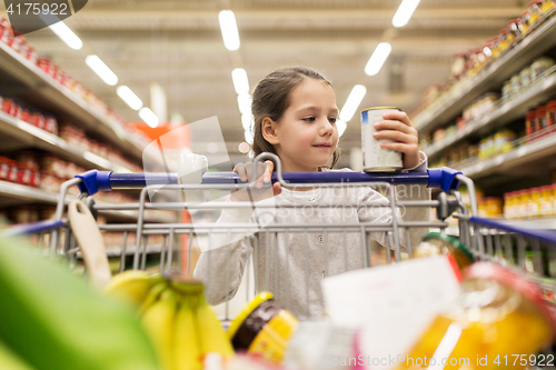 Image of girl with food in shopping cart at grocery store