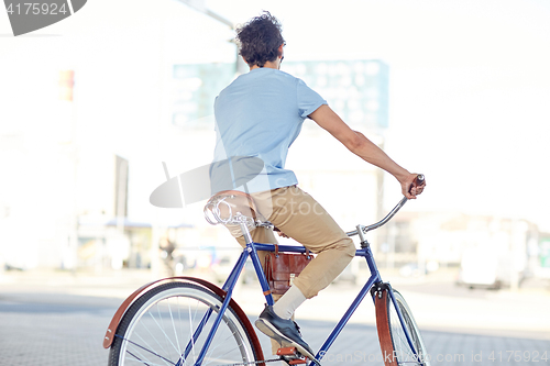 Image of hipster man riding fixed gear bike