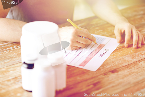 Image of close up of man with protein jars and diet plan