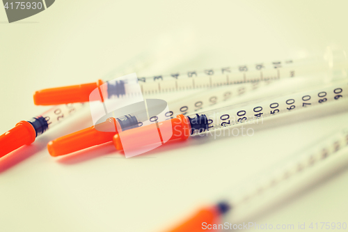 Image of close up of insulin syringes on table