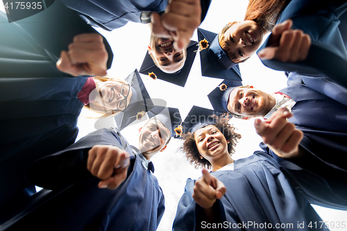 Image of happy students or bachelors pointing finger at you