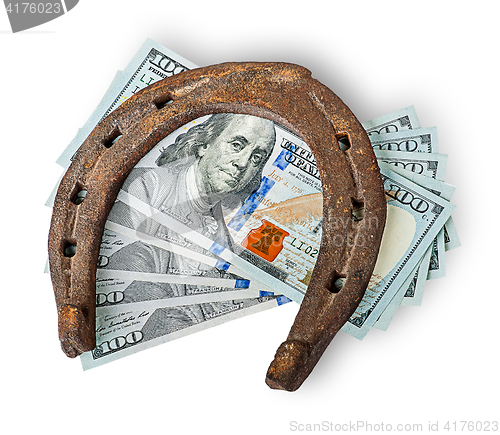 Image of Old rusty horseshoe and money