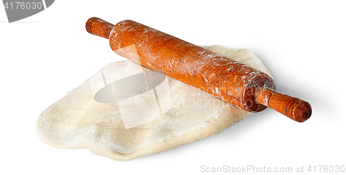 Image of Piece of dough is rolled out rolling pin