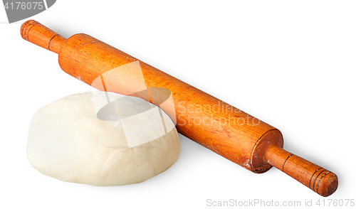 Image of Piece of dough beside rolling pin