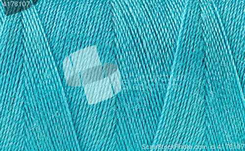 Image of Blue thread spooled on a bobbin