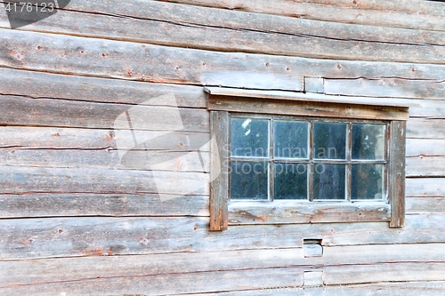 Image of Old log house window with rustic frame