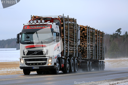 Image of Volvo FH Logging Truck Hauls Wood in Winter