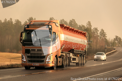 Image of Volvo FH Semi Bulk Transport Truck in Winter Afternoon Snowstorm