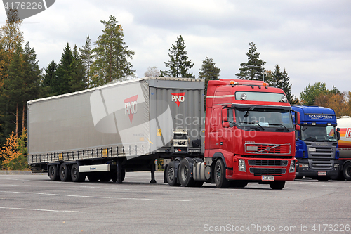 Image of Red Truck Backs Up Cargo Trailer