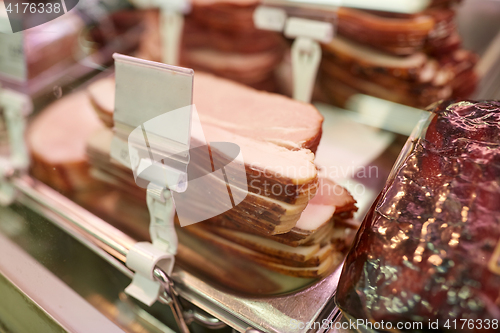 Image of ham at grocery store stall