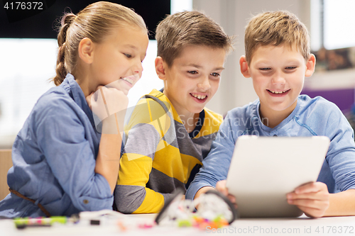 Image of kids with tablet pc programming at robotics school