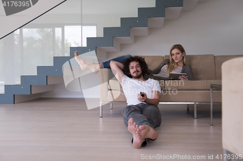 Image of young couple relaxes in the living room