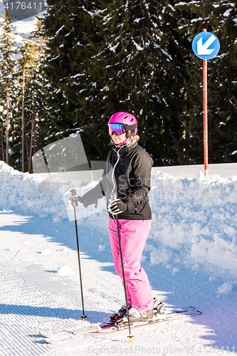 Image of attractive middle aged woman with ski and snow