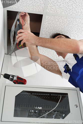 Image of Professional handy man worker mounts ceiling .