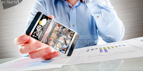 Image of Smartphone with transparent screen in human hands.