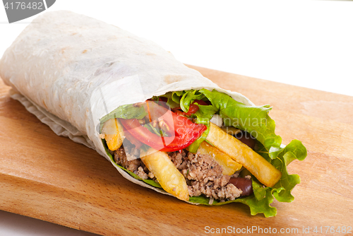 Image of beef burrito with peppers, fried potato and tomato