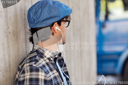 Image of man with earphones and smartphone listening music