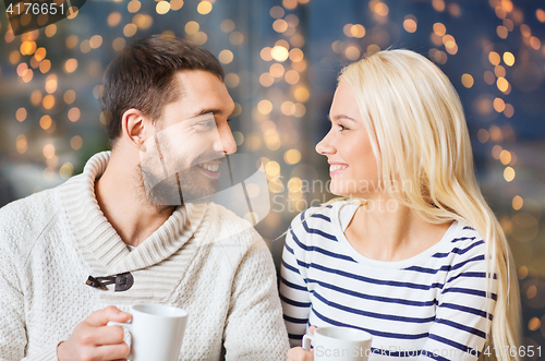 Image of happy couple drinking tea or coffee at cafe