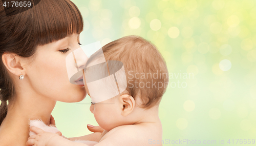 Image of happy mother kissing adorable baby