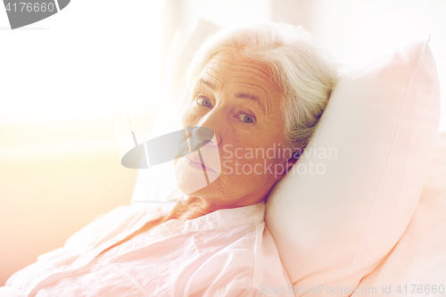 Image of senior woman patient lying in bed at hospital ward